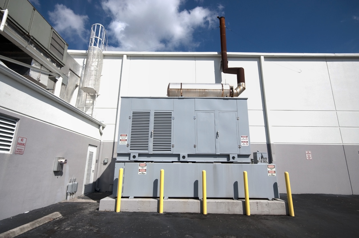 A diesel generator standby unit on the exterior of a building