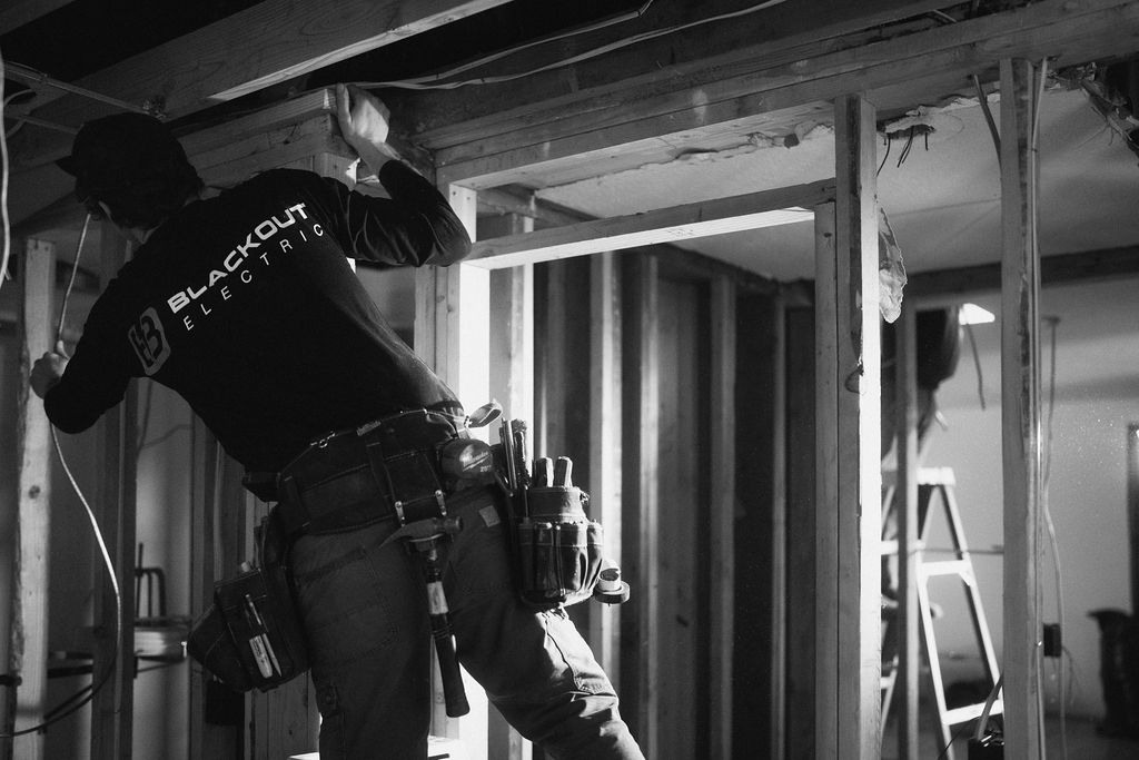 Blackout Electric technician performing electrical work
