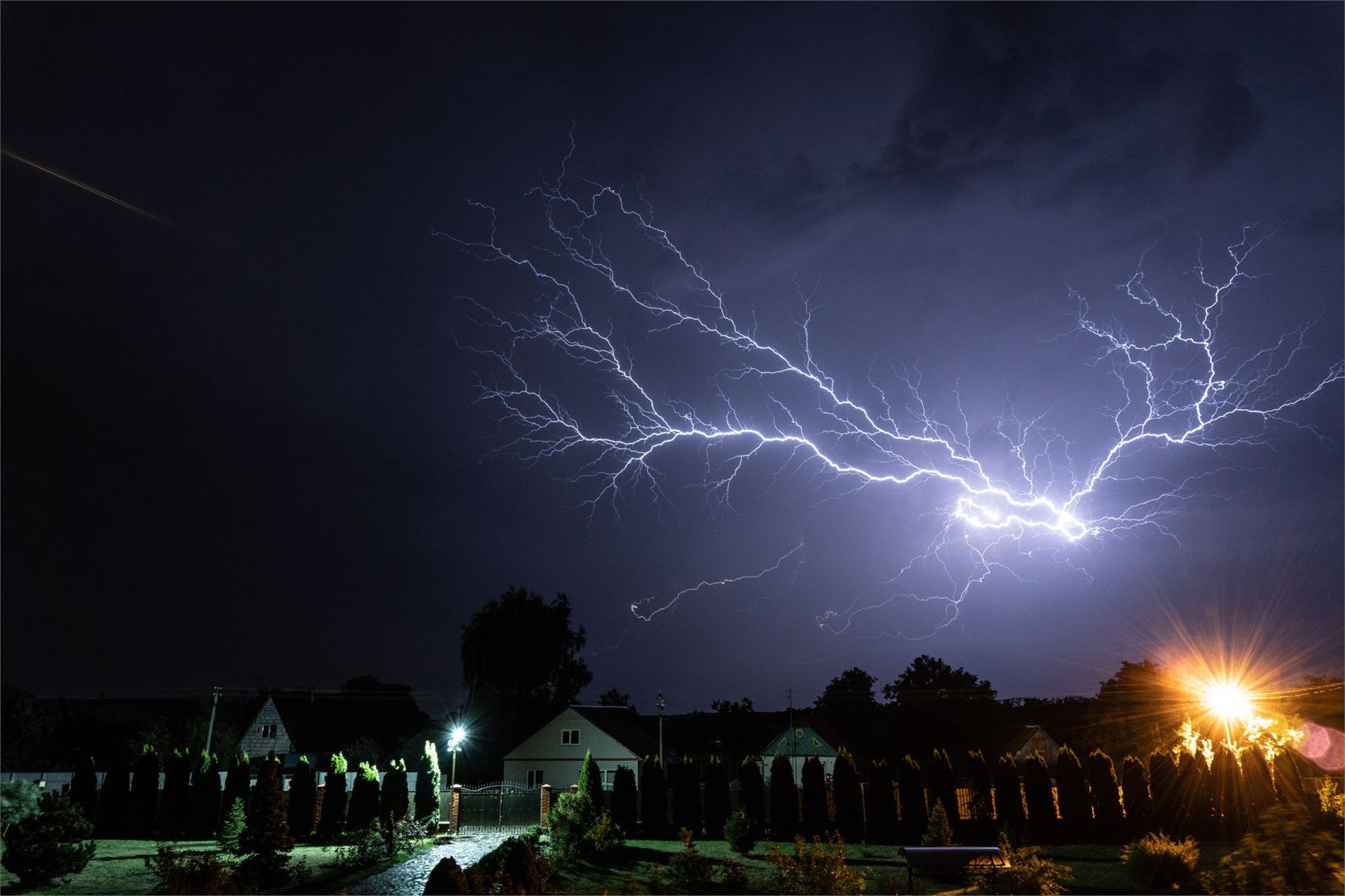 Lightning storm over a neighborhood during a power outage risk