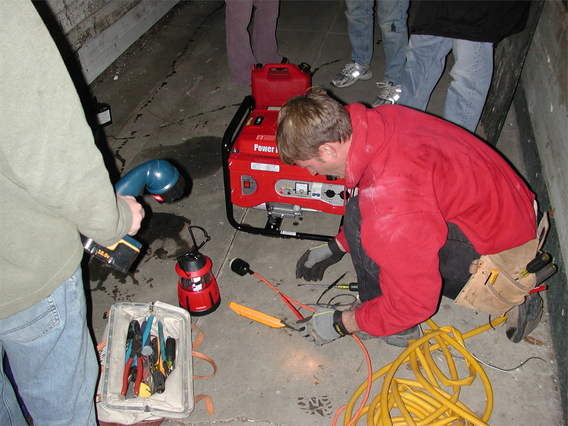 Electrician connecting portable backup generator equipment to a home's electrical system