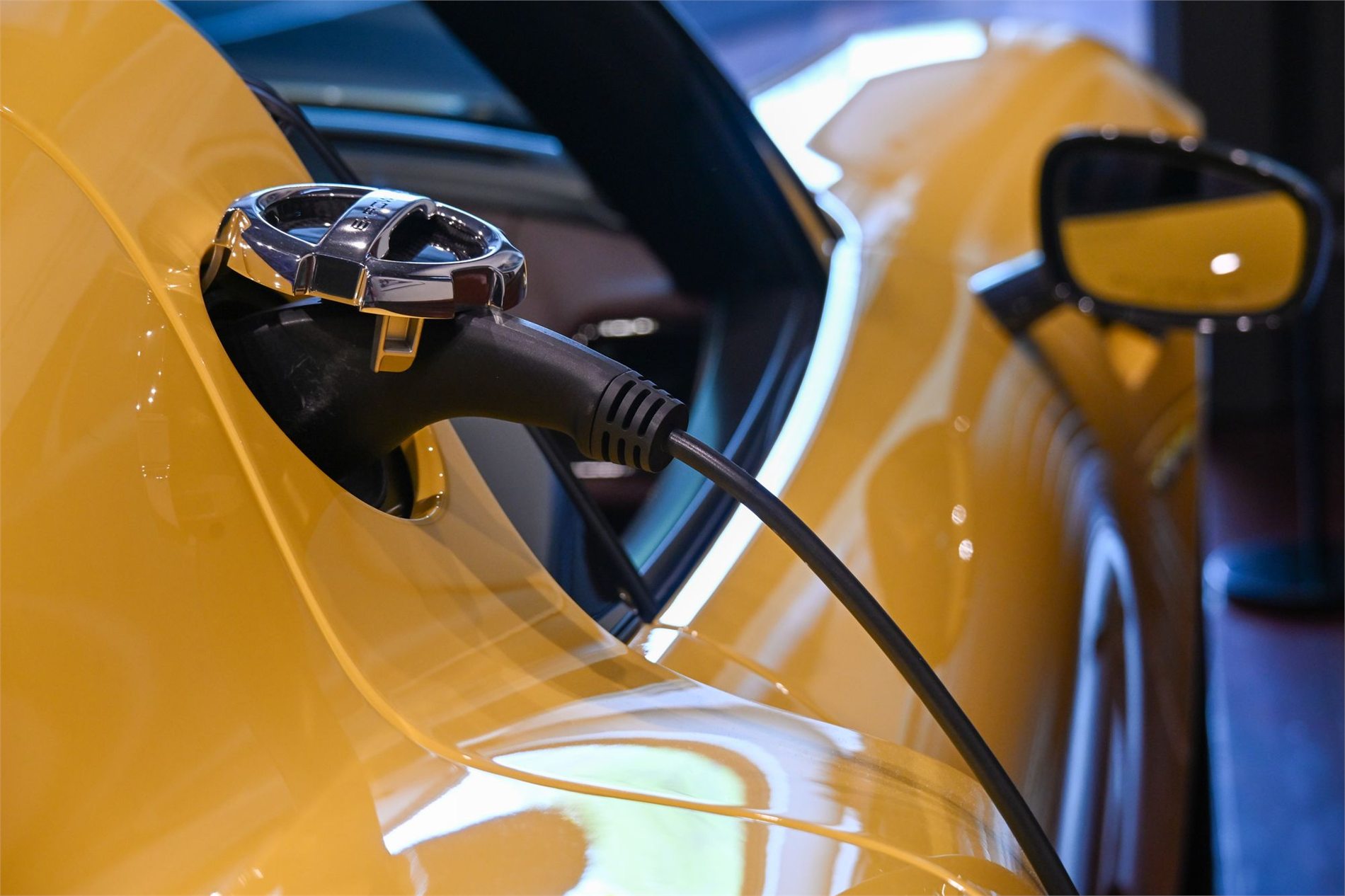Electric vehicle connected to a charging cable in a garage