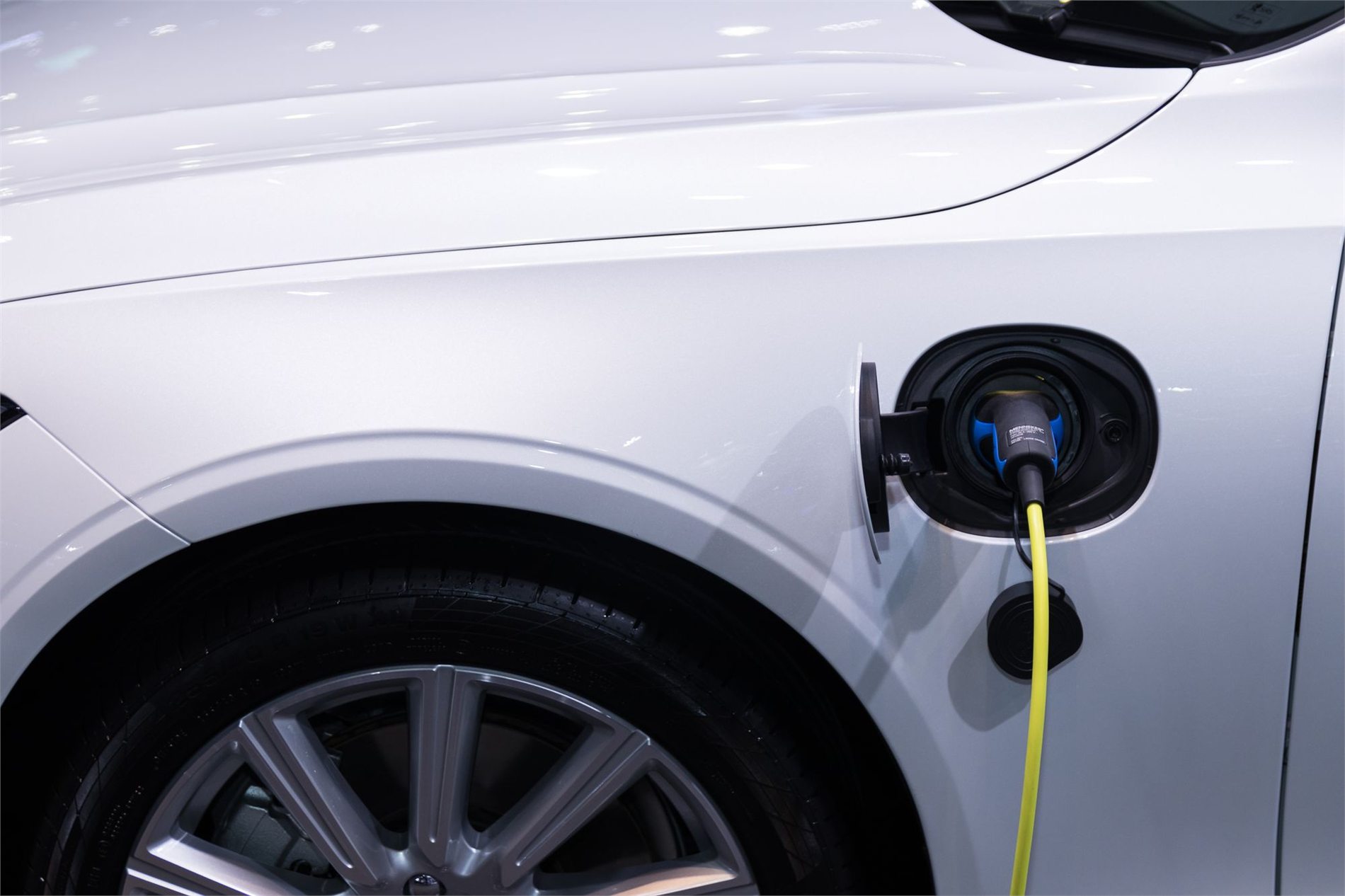 Charging cable connected to a white electric vehicle