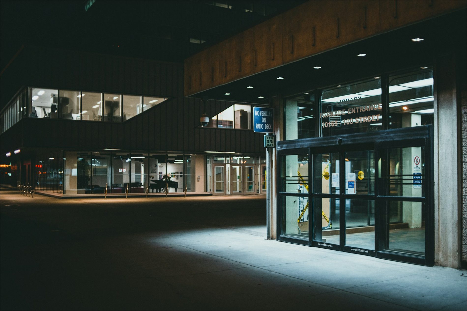 Commercial building and empty parking area illuminated at night