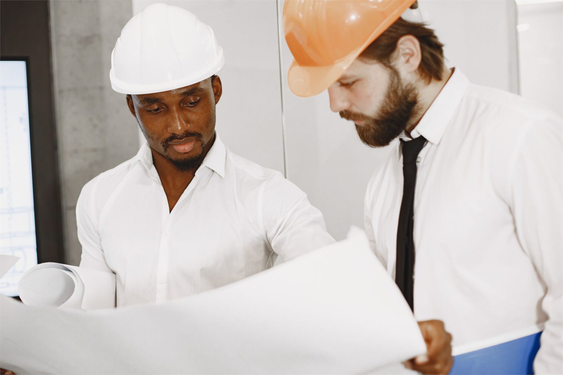 Engineers reviewing construction plans for a design-build project