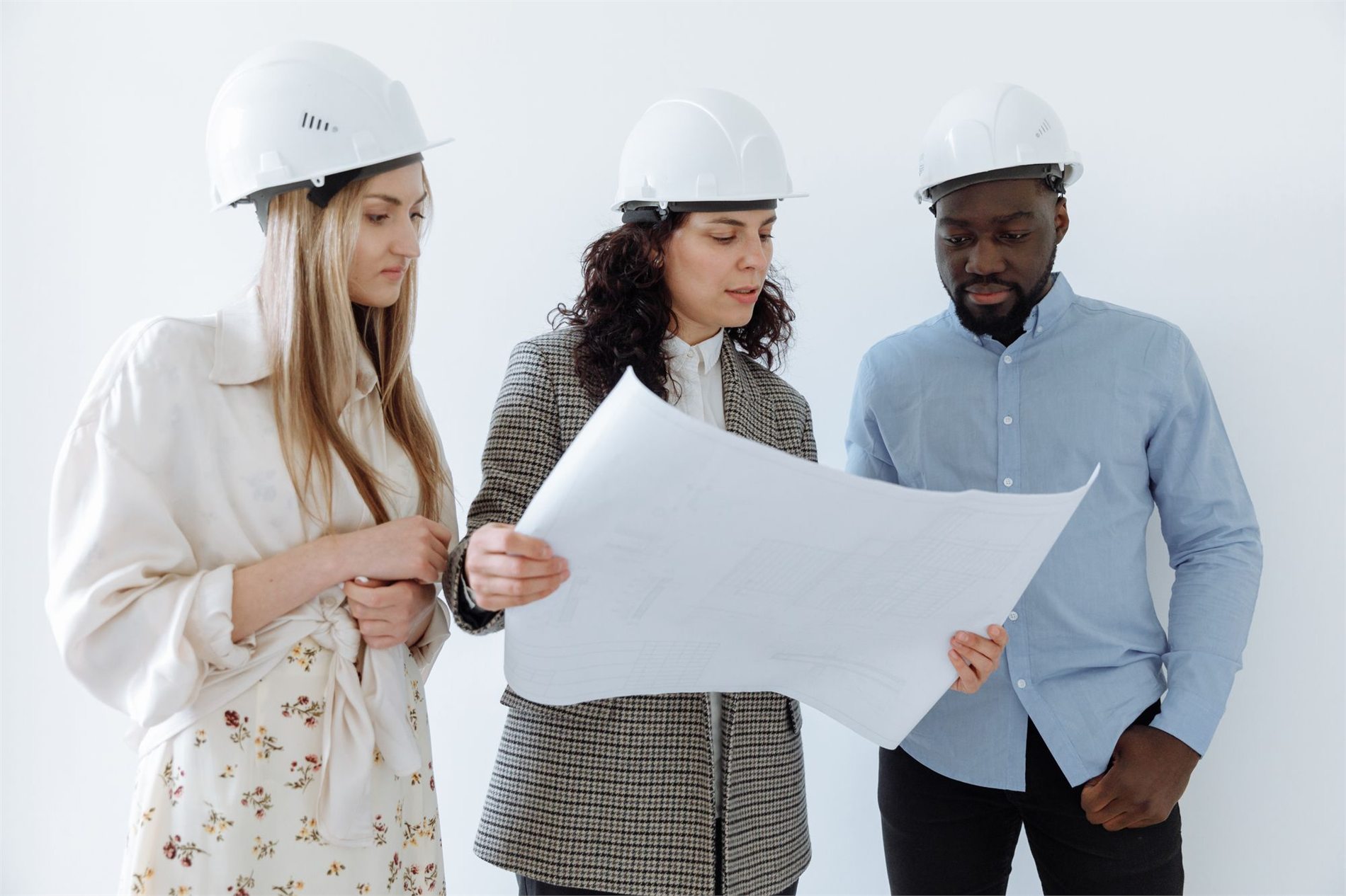 Construction team reviewing detailed design-build project plans