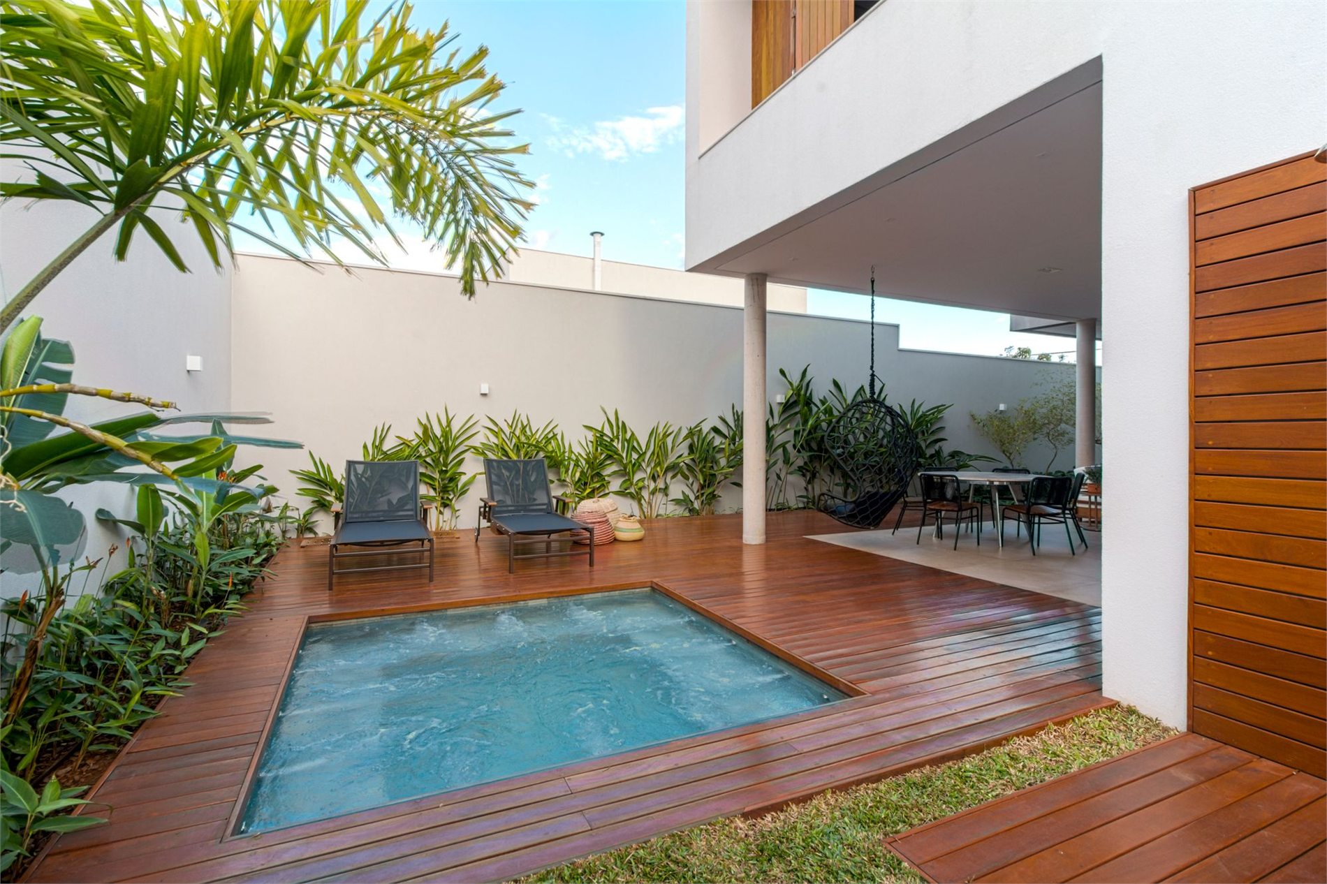Modern backyard patio with a built-in bubbling hot tub