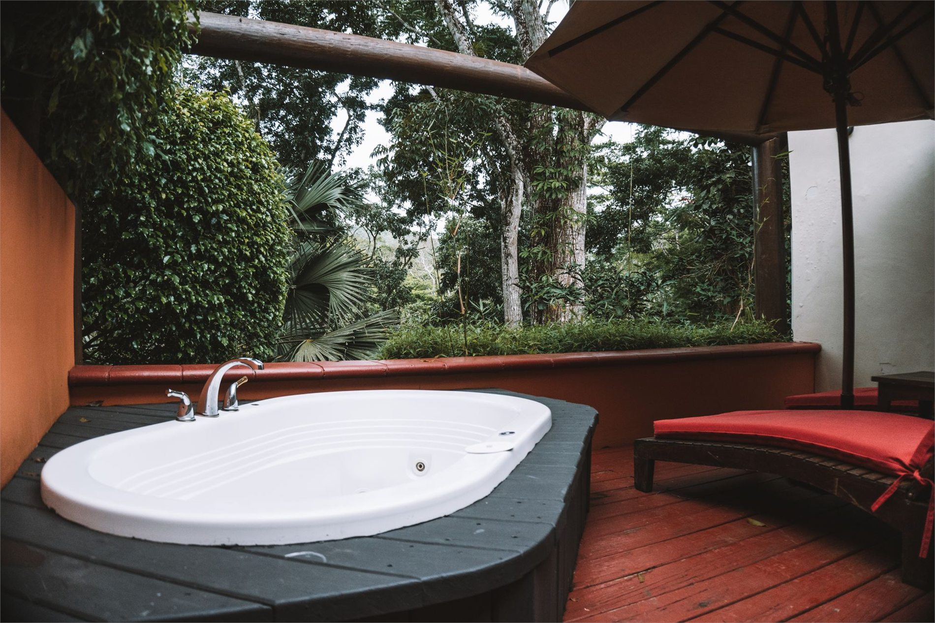 Outdoor jetted spa installed on a private wood terrace