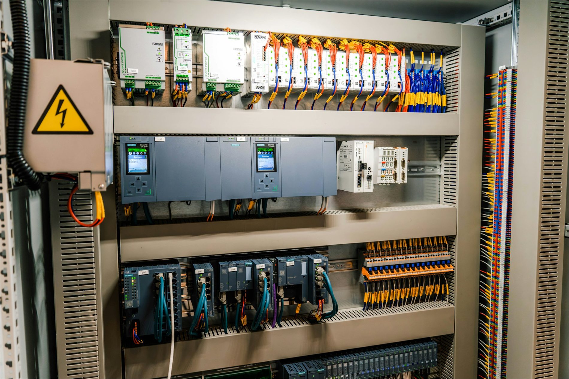 Industrial PLC control panel with organized wiring and electronic modules