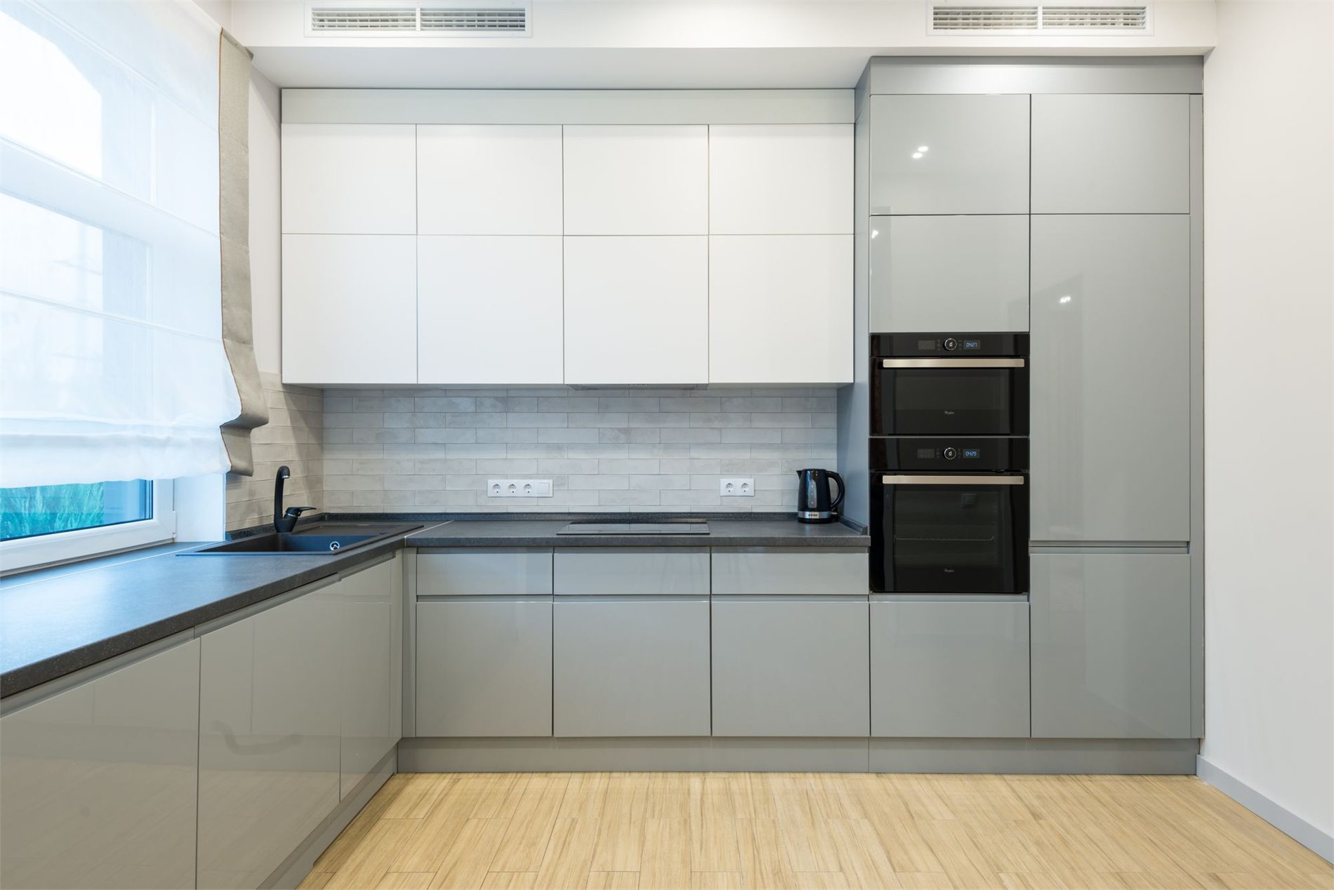 Contemporary kitchen with built-in electric ovens and cooktop